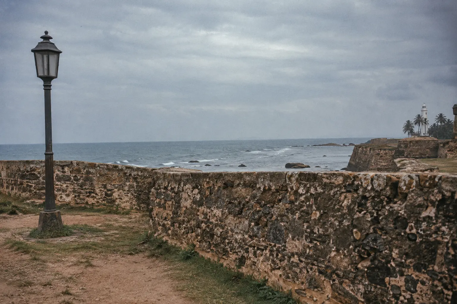 Weathered coral stone ramparts of Galle Fort with the Indian Ocean beyond