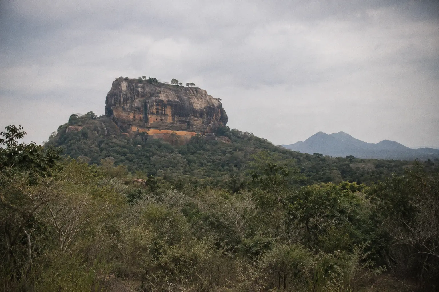 Sigiriya rock fortress rising above scrub forest on the dry central plains